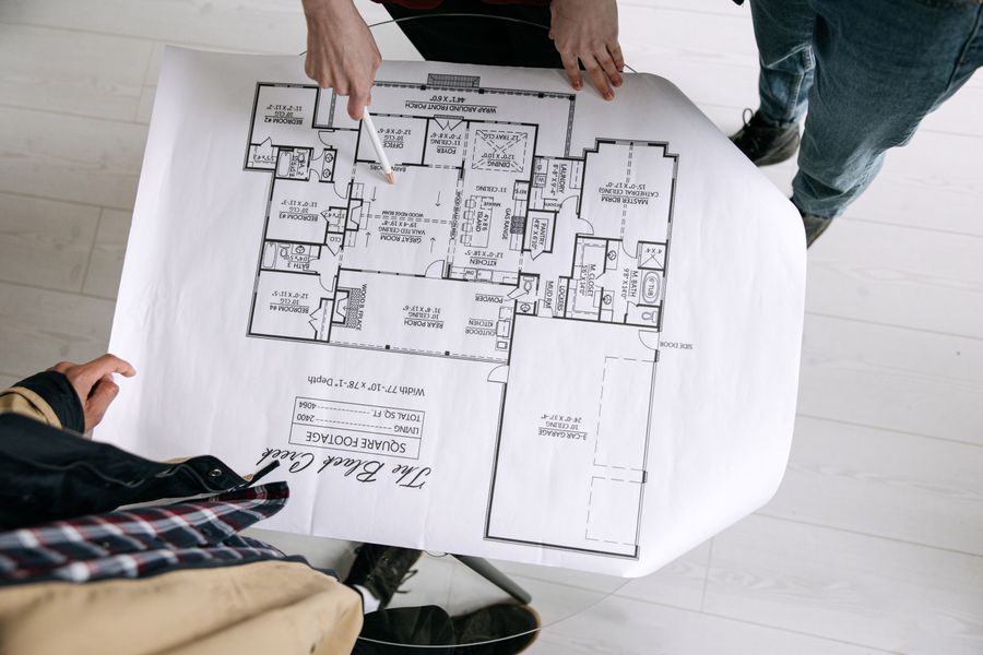 Architects reviewing a detailed technical floor plan